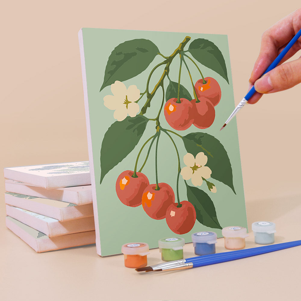 Painting an Orchard Harvest mini canvas propped up beside numbered acrylic paints