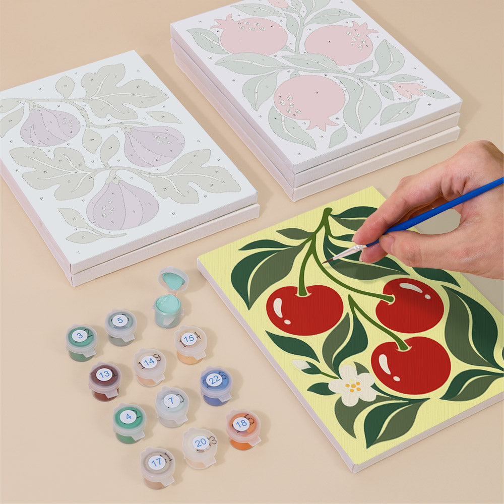 Painting one of the Orchard Prints designs next to a stack of mini canvases