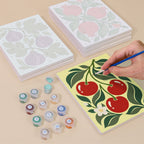 Painting one of the Orchard Prints designs next to a stack of mini canvases