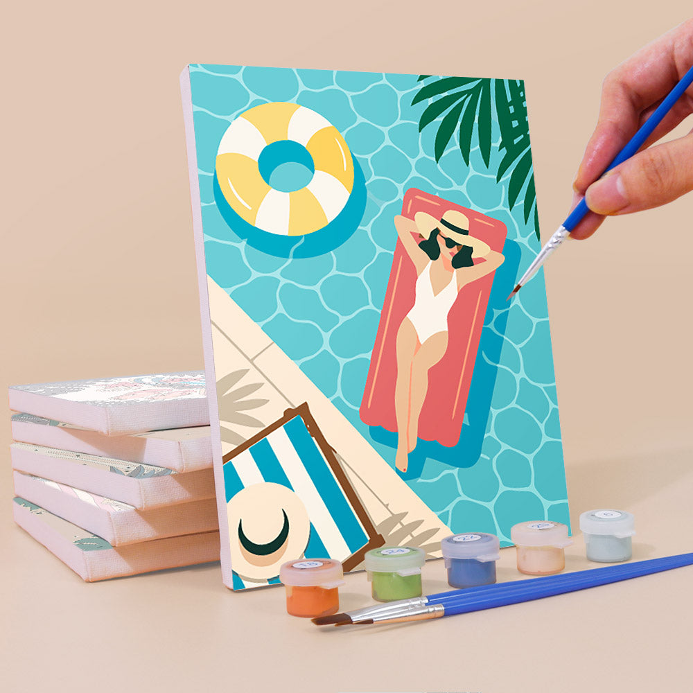 Painting a Palm Beach Holiday mini canvas propped up beside numbered acrylic paints