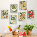 Six finished Pantry Harvest mini paintings hung on a wall above a table