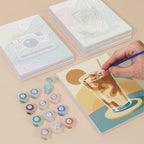 Painting one of the Pastel Favorites designs next to a stack of mini canvases