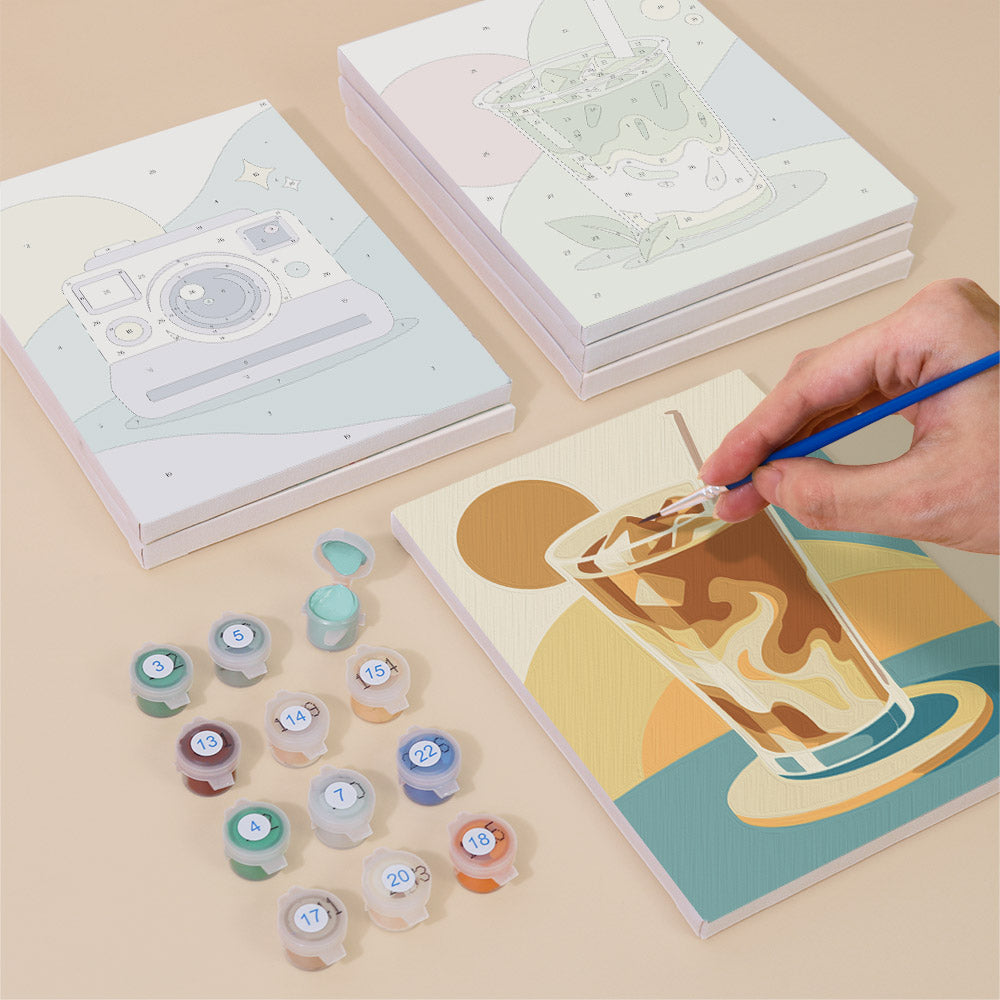 Painting one of the Pastel Favorites designs next to a stack of mini canvases