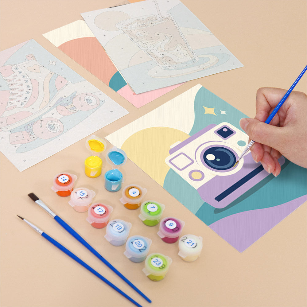 Filling in a Pastel Favorites mini canvas with numbered acrylic paints and a fine brush
