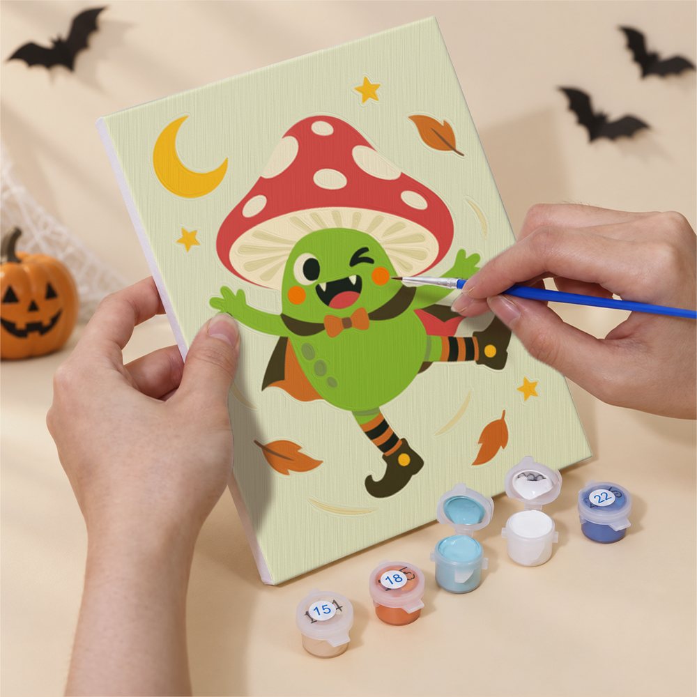 Hand holding a Pastel Halloween Pals mini canvas while painting the details