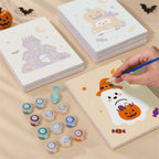 Painting one of the Pastel Pumpkin Pals designs next to a stack of mini canvases