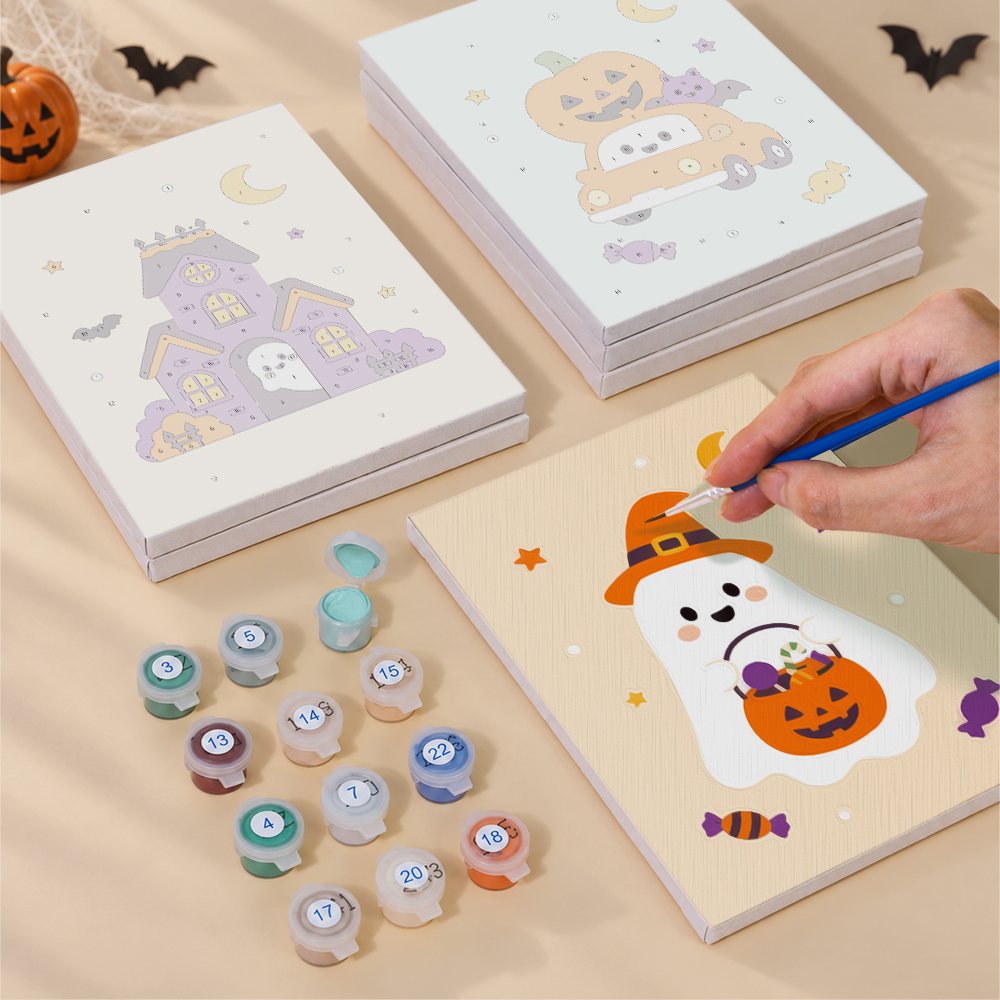 Painting one of the Pastel Pumpkin Pals designs next to a stack of mini canvases