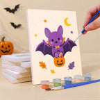 Painting a Pastel Pumpkin Pals mini canvas propped up beside numbered acrylic paints