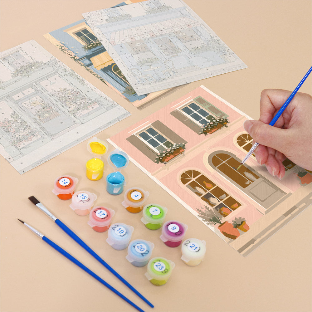 Filling in a Pastel Storefronts mini canvas with numbered acrylic paints and a fine brush