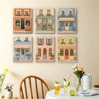 Pastel Storefronts mini paintings displayed as a gallery wall in a sunny kitchen