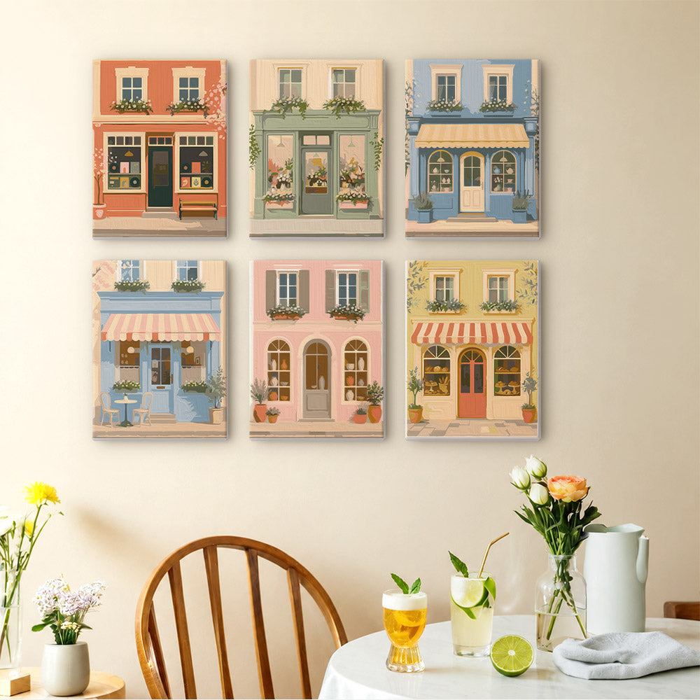 Pastel Storefronts mini paintings displayed as a gallery wall in a sunny kitchen