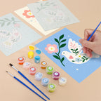 Filling in a Peace Doves mini canvas with numbered acrylic paints and a fine brush