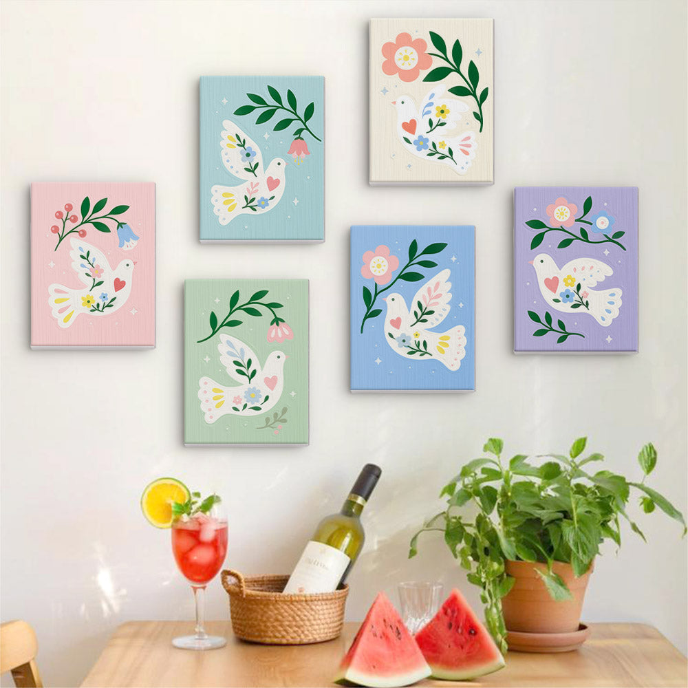 Six finished Peace Doves mini paintings hung on a wall above a table