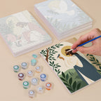 Painting one of the Peaceful Faith designs next to a stack of mini canvases