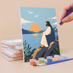 Painting a Peaceful Faith mini canvas propped up beside numbered acrylic paints