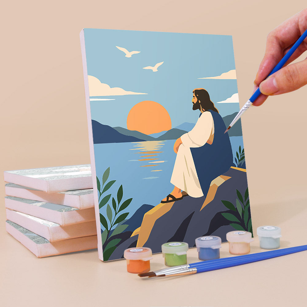 Painting a Peaceful Faith mini canvas propped up beside numbered acrylic paints