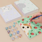 Painting one of the Peekaboo Kittens designs next to a stack of mini canvases