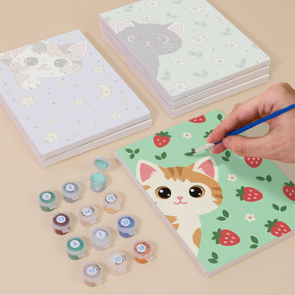 Painting one of the Peekaboo Kittens designs next to a stack of mini canvases