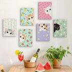 Six finished Peekaboo Kittens mini paintings hung on a wall above a table