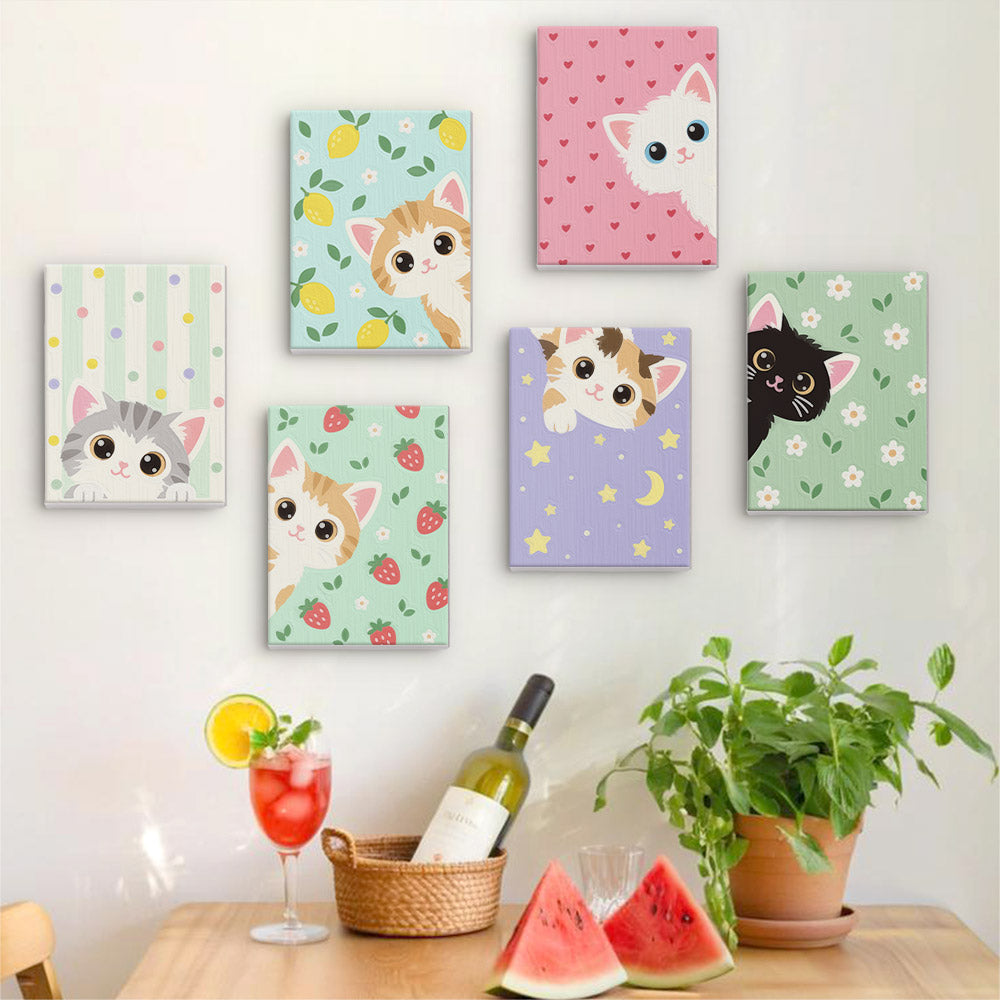 Six finished Peekaboo Kittens mini paintings hung on a wall above a table