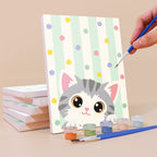 Painting a Peekaboo Kittens mini canvas propped up beside numbered acrylic paints