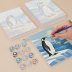 Painting one of the Penguin Shores designs next to a stack of mini canvases