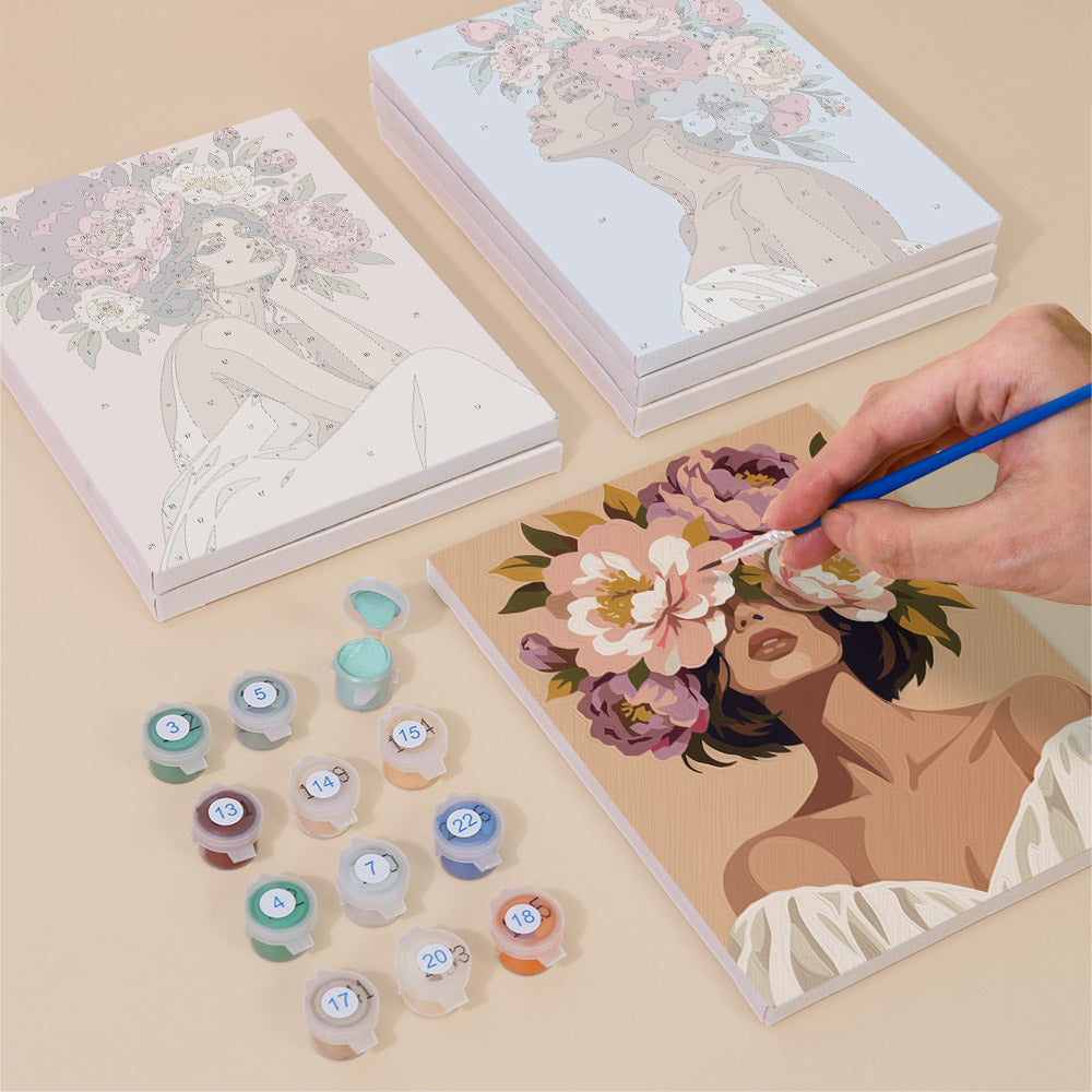 Painting one of the Peony Portraits designs next to a stack of mini canvases
