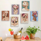 Six finished Peony Portraits mini paintings hung on a wall above a table