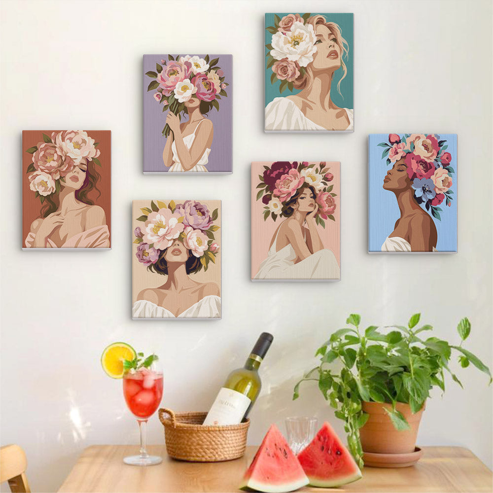 Six finished Peony Portraits mini paintings hung on a wall above a table