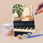 Painting a Piano Moments mini canvas propped up beside numbered acrylic paints