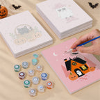 Painting one of the Pink Boo Crew designs next to a stack of mini canvases