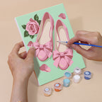 Hand holding a Pink Glam mini canvas while painting the details