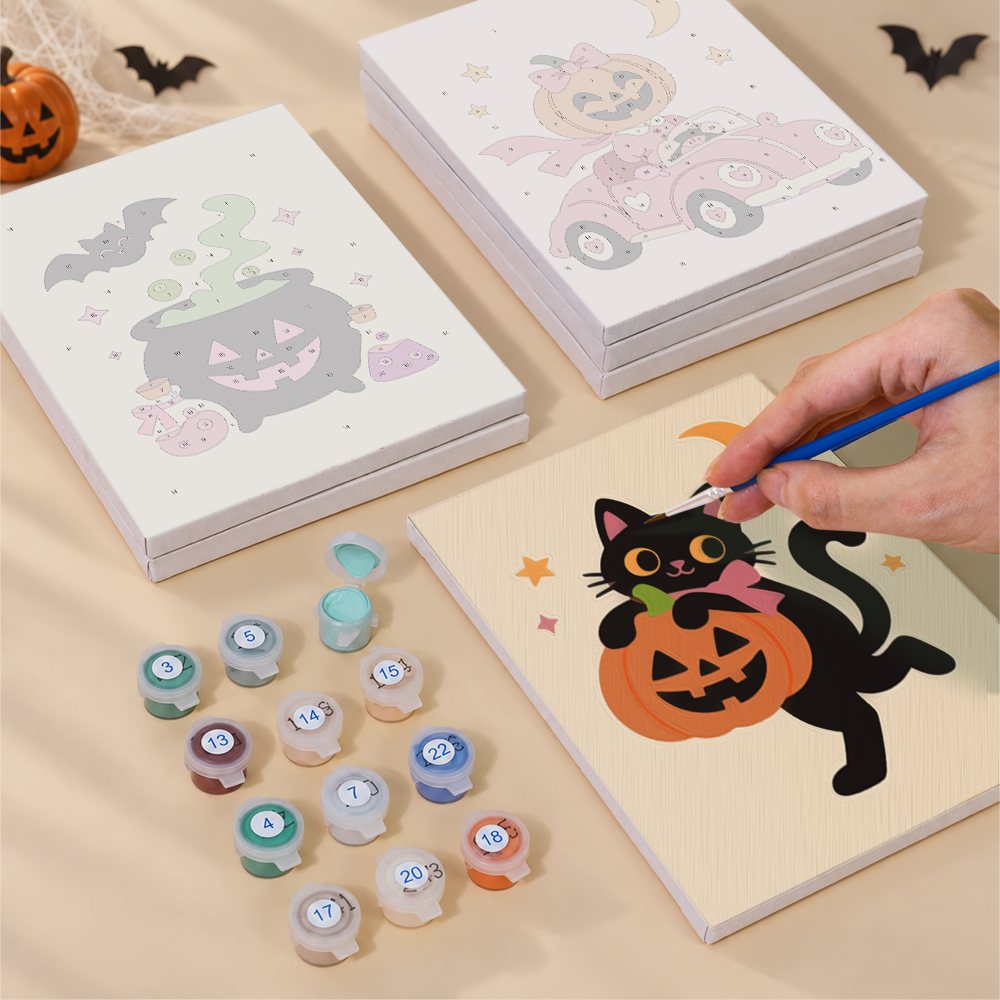 Painting one of the Pink Pumpkin Party designs next to a stack of mini canvases