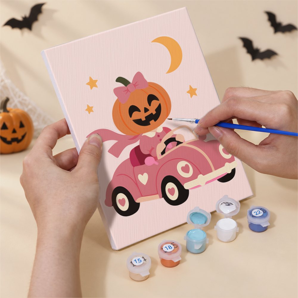 Hand holding a Pink Pumpkin Party mini canvas while painting the details