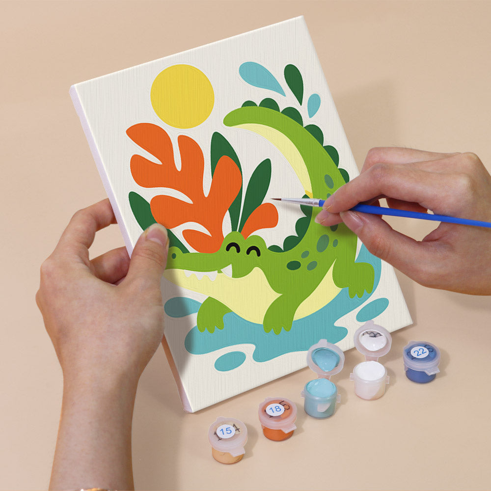 Hand holding a Playful Garden mini canvas while painting the details