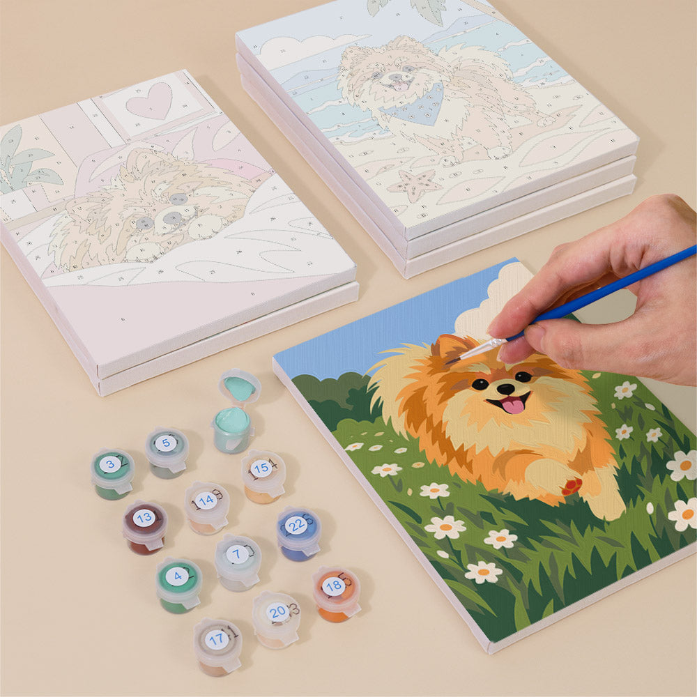 Painting one of the Pomeranian Days designs next to a stack of mini canvases