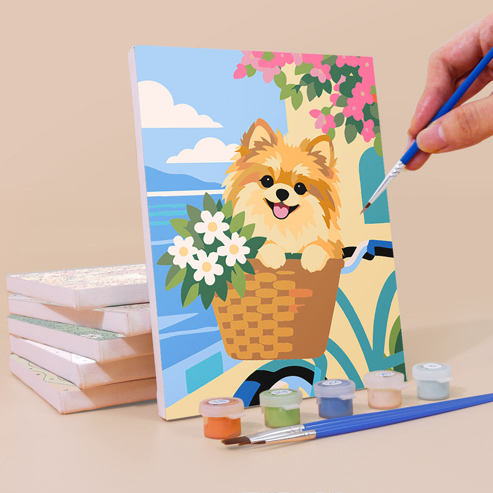 Painting a Pomeranian Days mini canvas propped up beside numbered acrylic paints