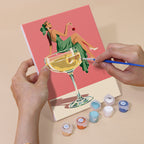 Hand holding a Poolside Cocktails mini canvas while painting the details