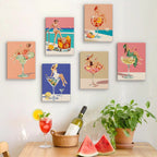 Six finished Poolside Cocktails mini paintings hung on a wall above a table