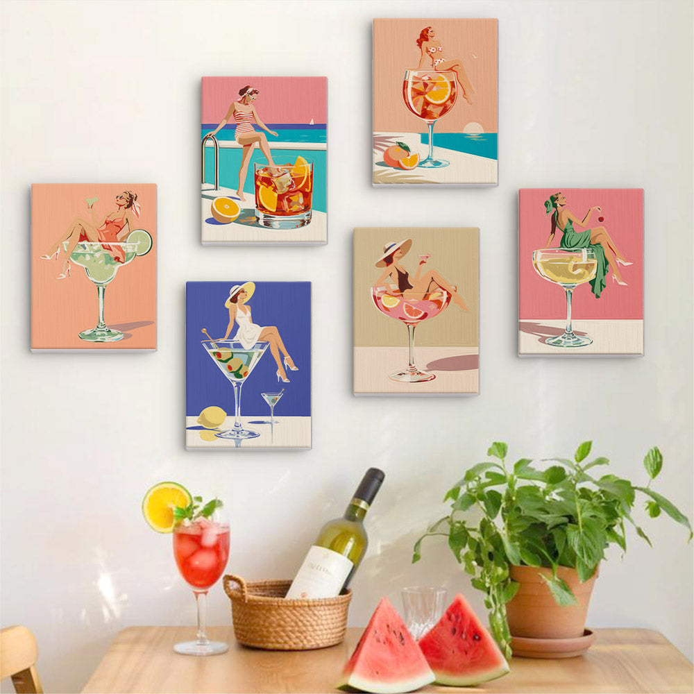Six finished Poolside Cocktails mini paintings hung on a wall above a table