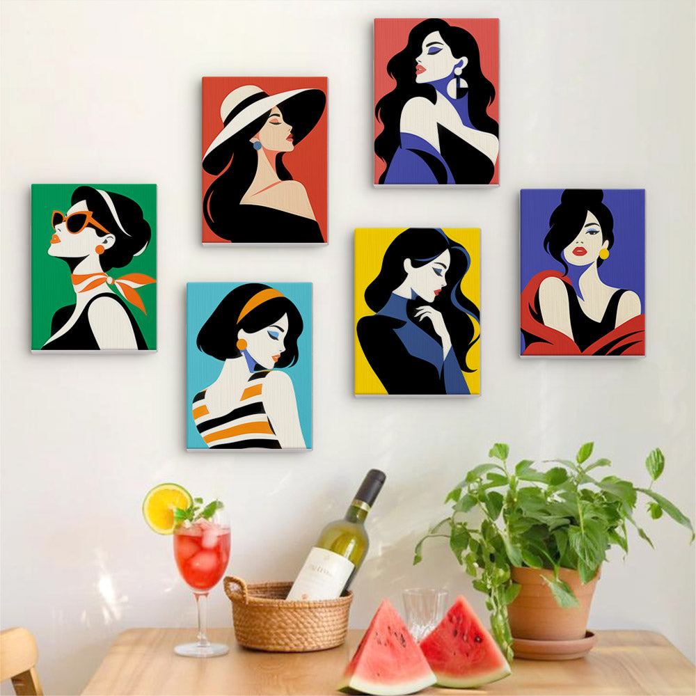 Six finished Pop Art Ladies mini paintings hung on a wall above a table