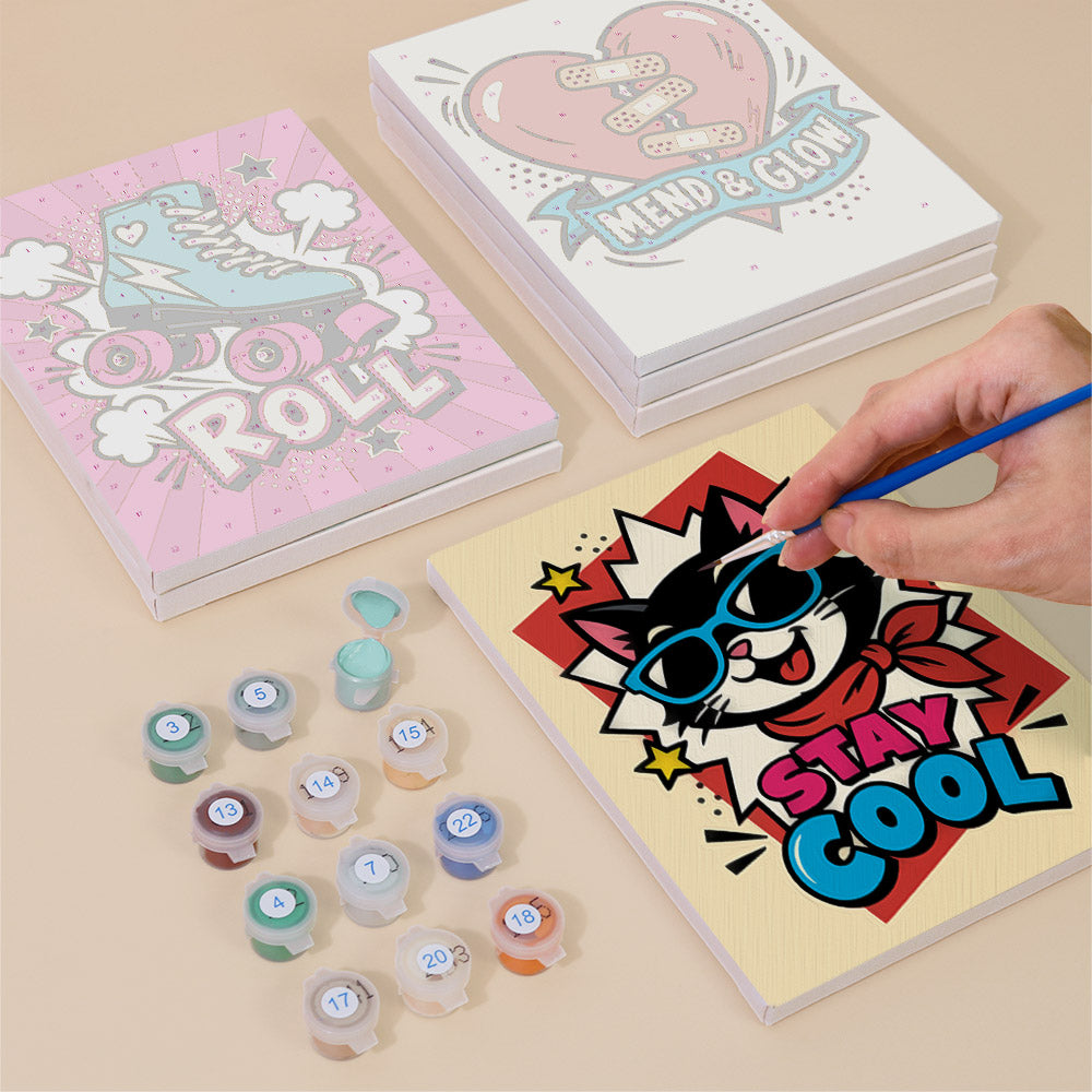 Painting one of the Pop Attitude designs next to a stack of mini canvases
