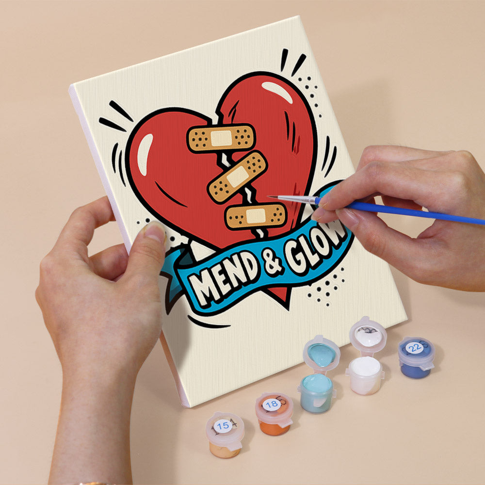 Hand holding a Pop Attitude mini canvas while painting the details