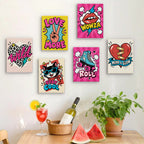 Six finished Pop Attitude mini paintings hung on a wall above a table