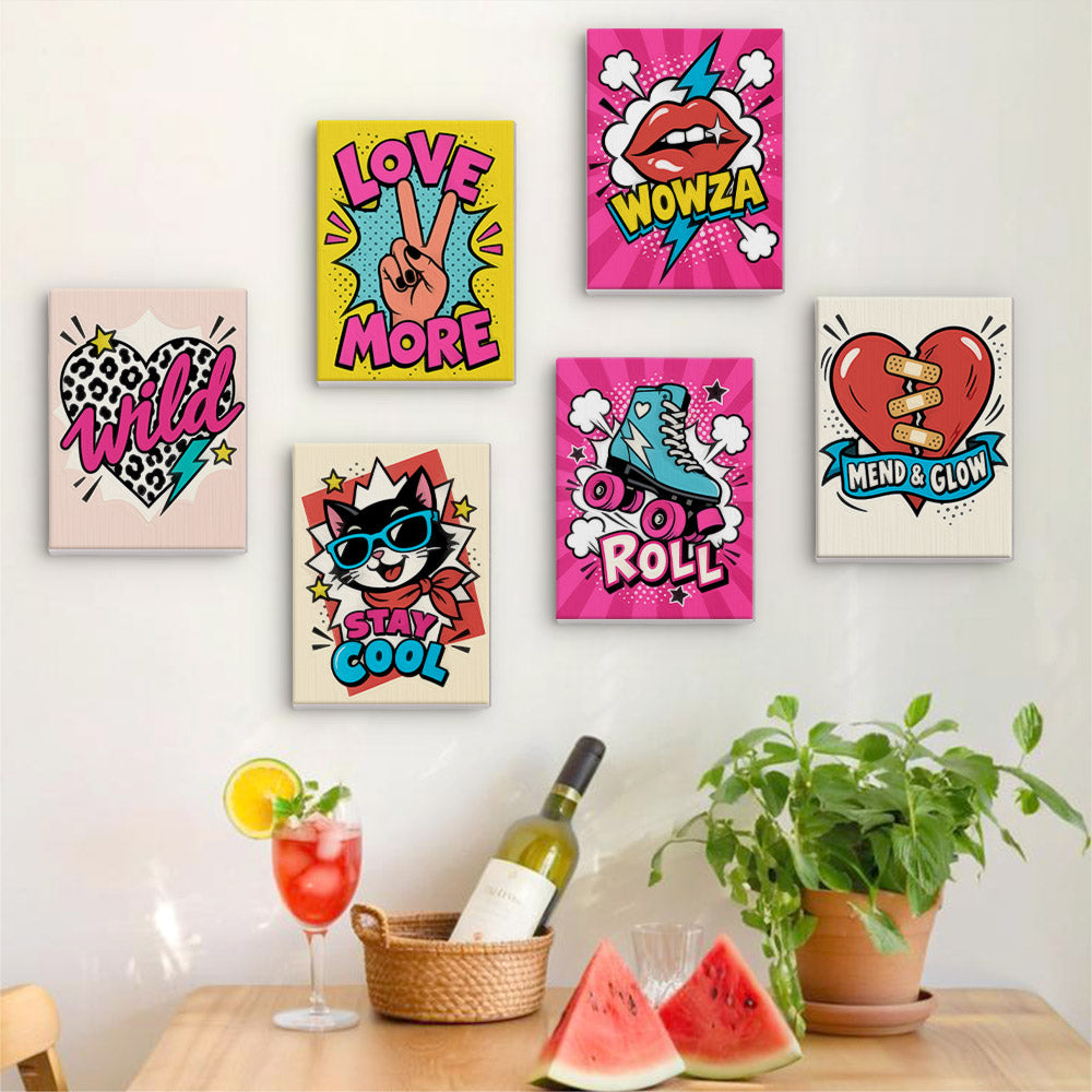 Six finished Pop Attitude mini paintings hung on a wall above a table