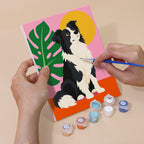 Hand holding a Pop Pups mini canvas while painting the details