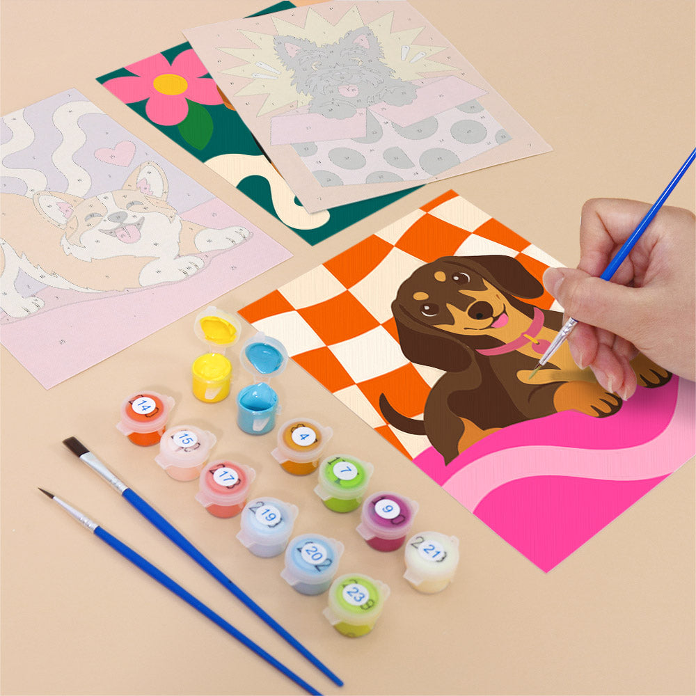 Filling in a Pop Pups mini canvas with numbered acrylic paints and a fine brush