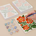 Painting one of the Poppy Parade designs next to a stack of mini canvases