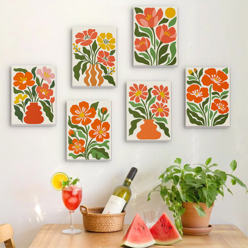 Six finished Poppy Parade mini paintings hung on a wall above a table