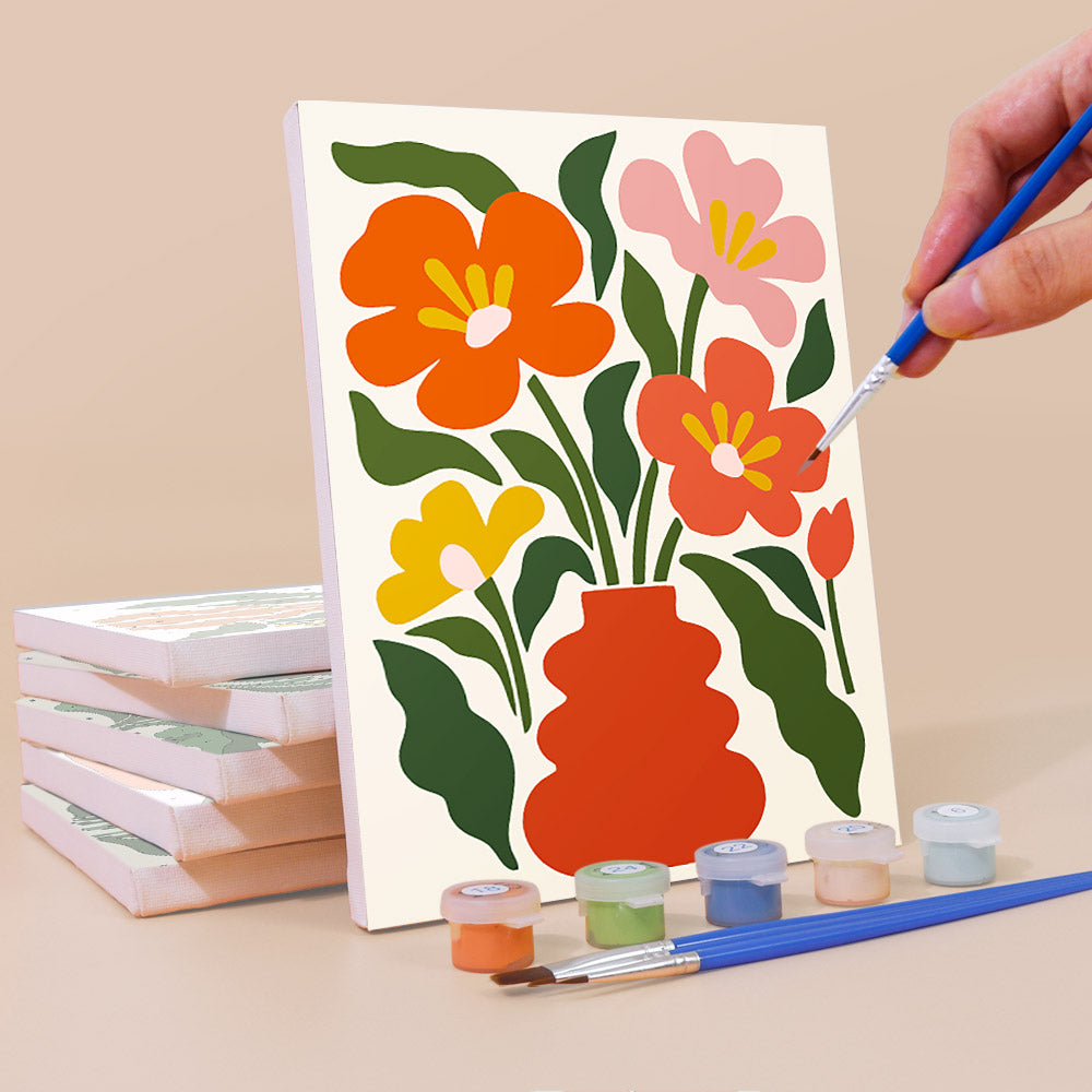 Painting a Poppy Parade mini canvas propped up beside numbered acrylic paints